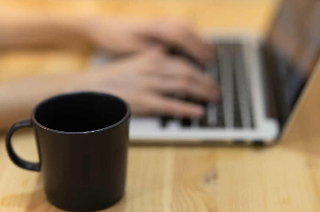 person working at desk with laptop